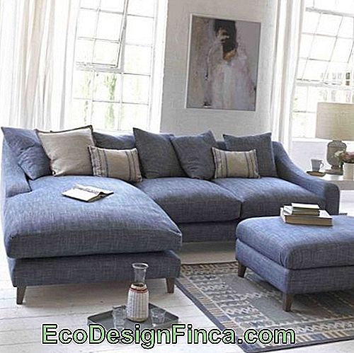 Blue corner sofa with light cushions.