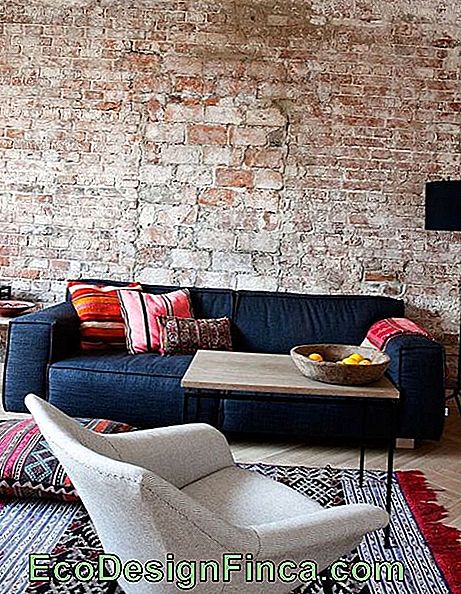 Spacious two-seat sofa in front of the brick wall.