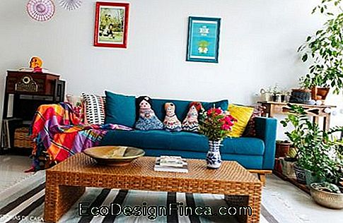 Blue sofa in living room, with colorful cushions.