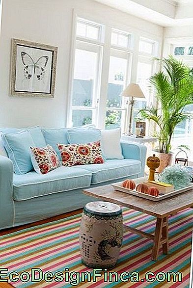 Living room with light sofa and striped rug.