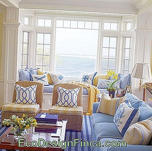 Living room with blue sofa and armchairs with neutral tones.