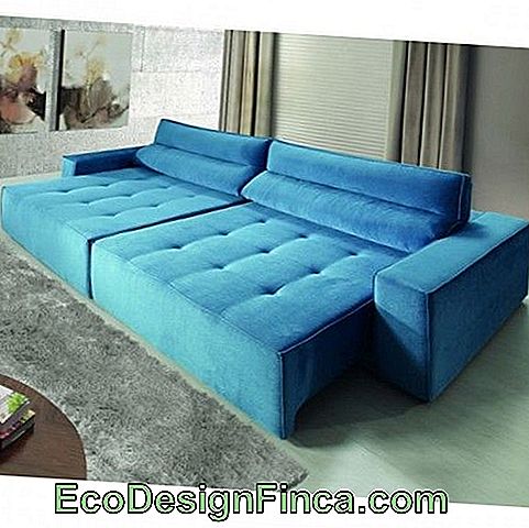 Retractable blue sofa in room with pastel shades.