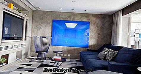Room with geometric floor and blue sofa.