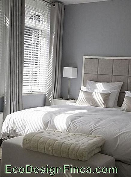 Gray curtain in double room with white linen.