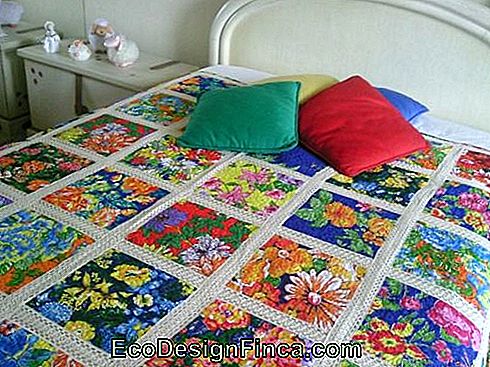 patchwork quilt with crocheted flowers