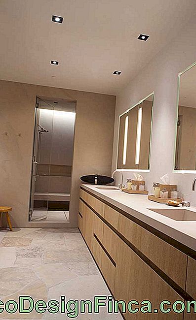 The bathroom was modern and elegant with yellow Sao Tome stone with cut coraco
